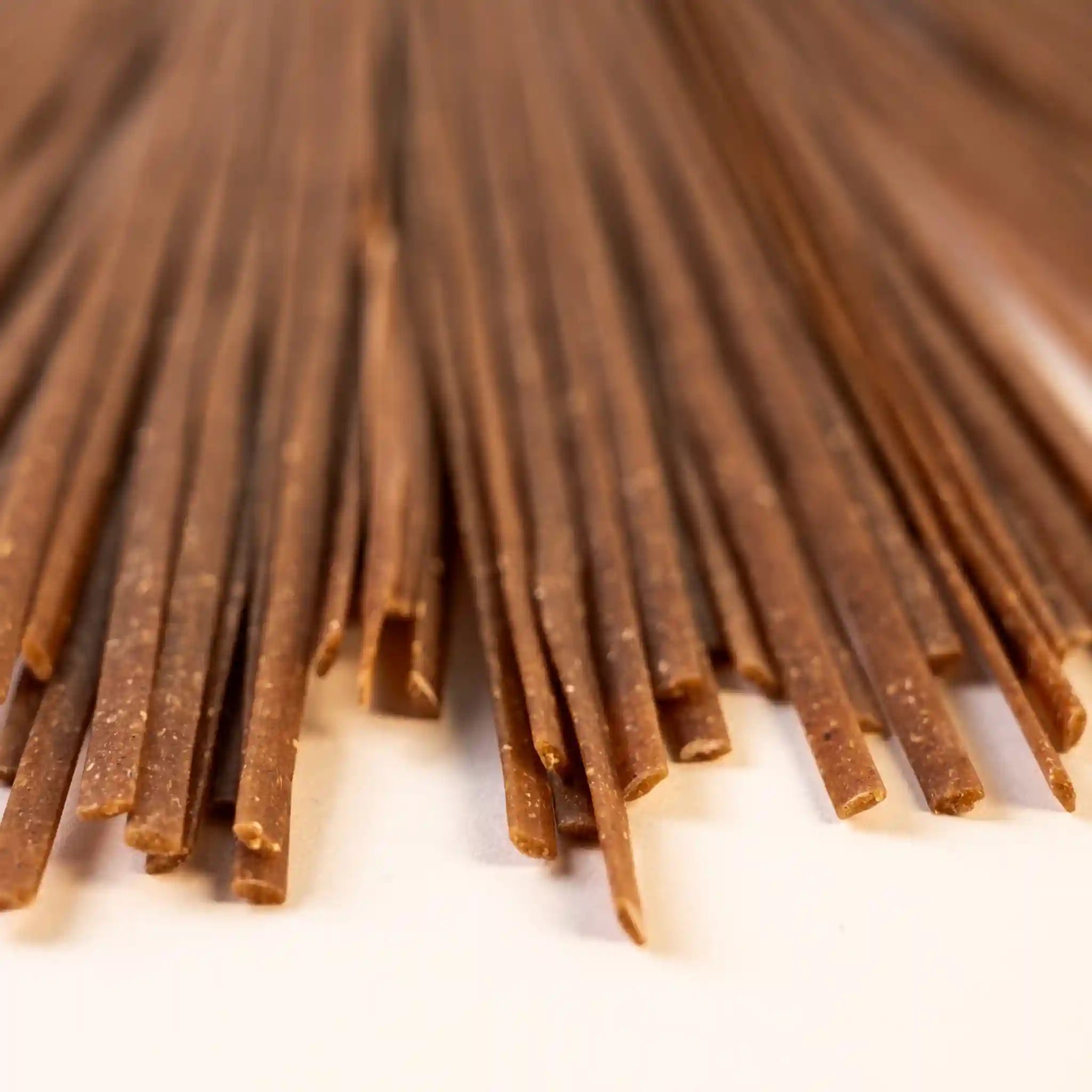 Close-up of multiple pieces of uncooked Organic Einkorn Linguine